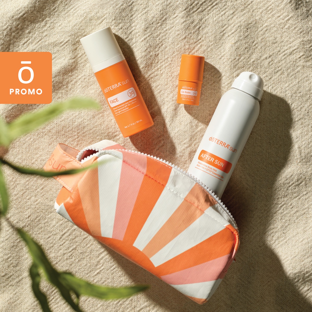 doTERRA Sun essentials flat lay — Face sunscreen, Lip Balm, and After Sun mist with the travel pouch